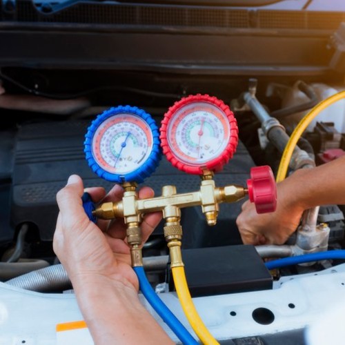 a man plugin in an aircon regas pipes